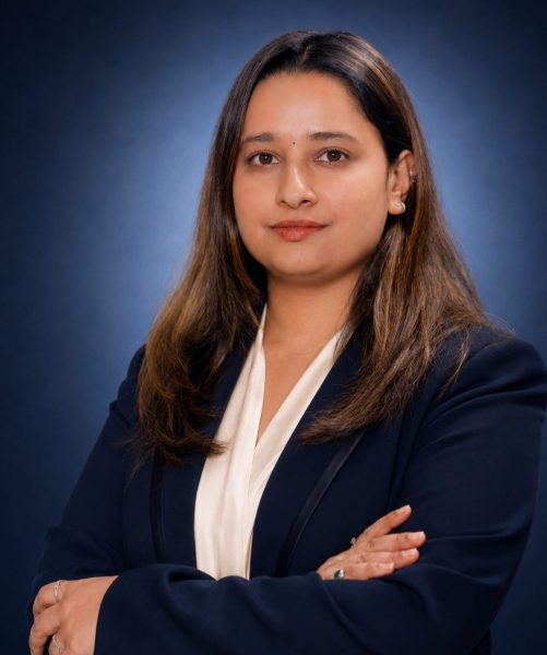 Kusum Parajuli, Legal Officer at Emigrate Lawyers, in professional navy attire.